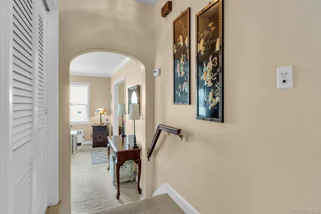 a view of a hallway with a furniture and entryway