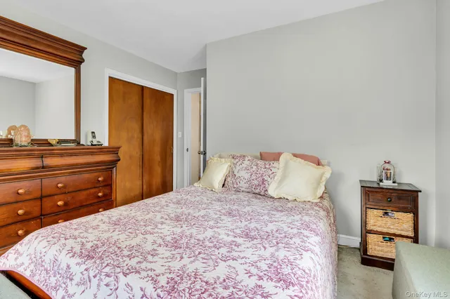 a bedroom with a bed and a dresser in it