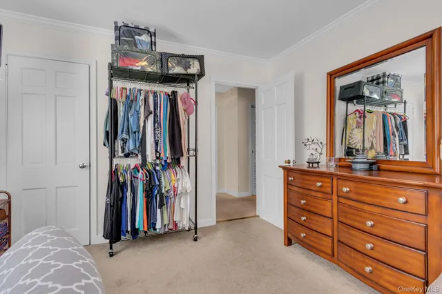 a view of walk in closet with clothes