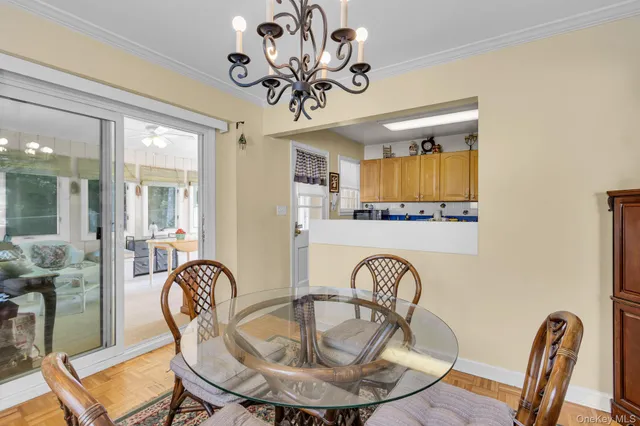 a view of a dining room with furniture wooden floor and chandelier