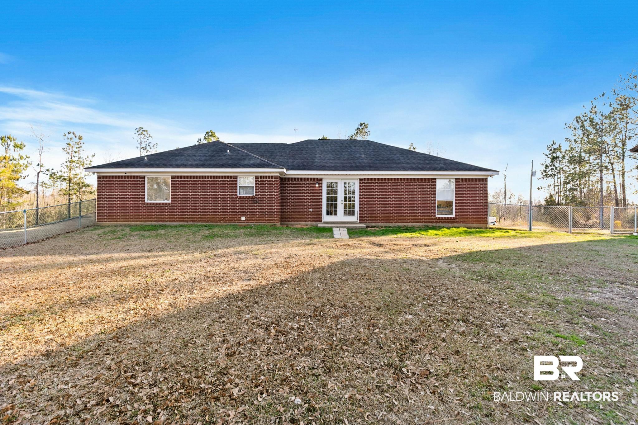 55750 Lottie Road Perdido, AL 36562 - Photo 36 of 84 Rear view of property featuring a fenced backyard, french doors, and brick siding
