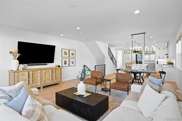 a living room with furniture a large window and a flat screen tv