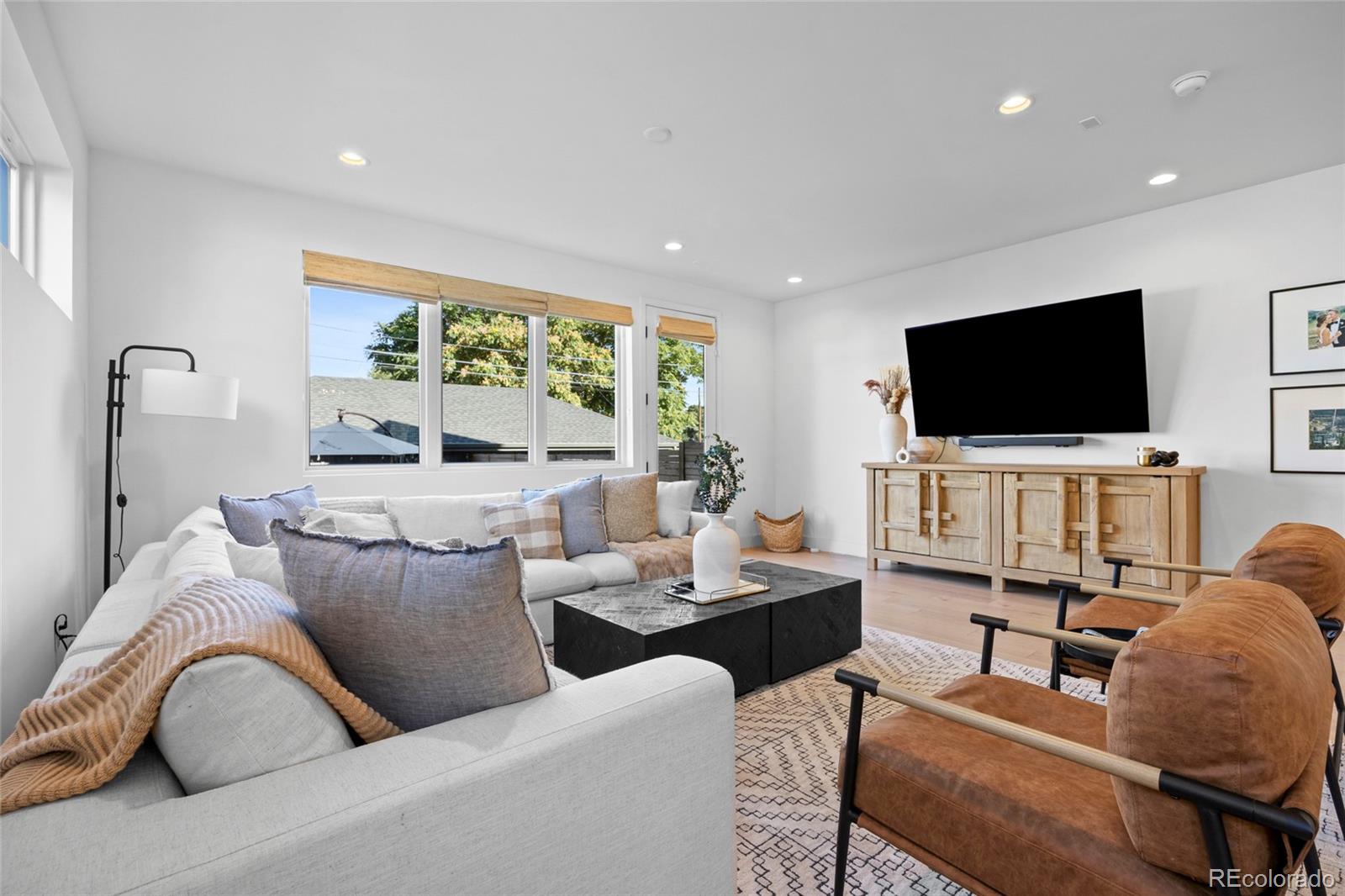 3922 Osage Street Denver, CO 80211 - Photo 13 of 44 a living room with furniture and a flat screen tv