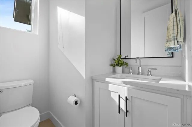 a bedroom with a bed and a potted plant