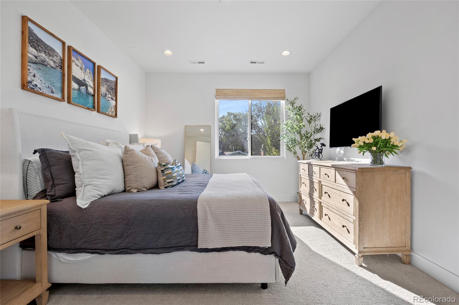 3922 Osage Street Denver, CO 80211 - Photo 20 of 44 a bedroom with a bed and a flat screen tv