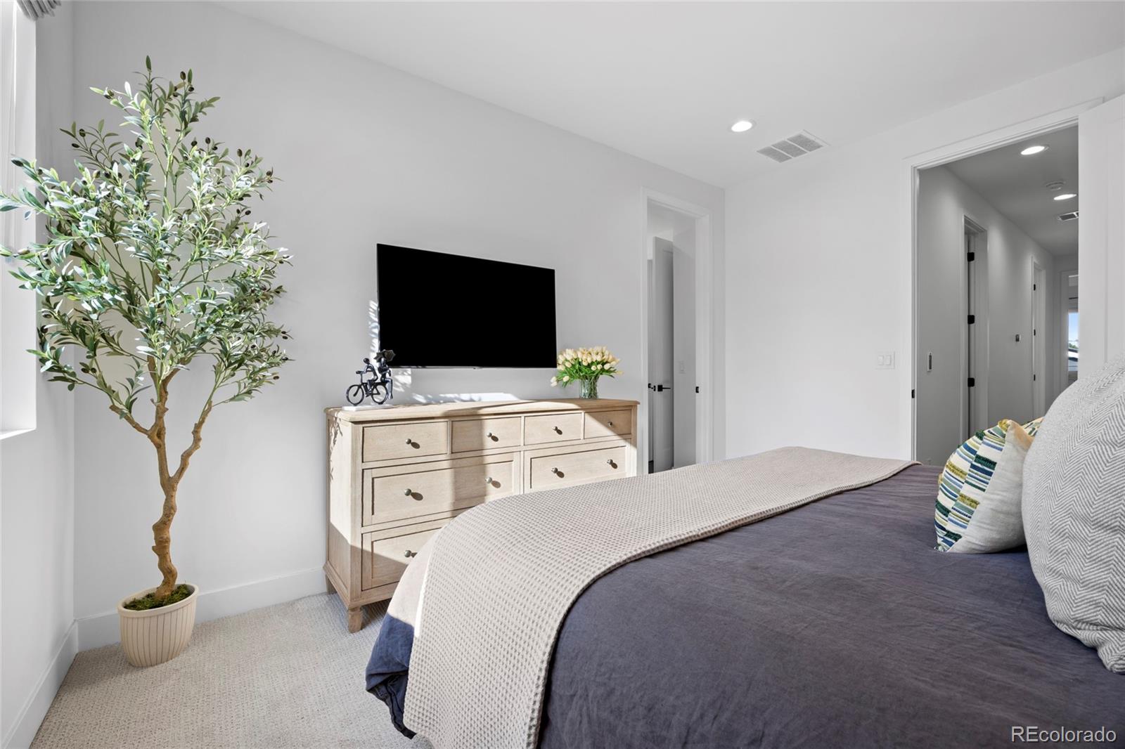 3922 Osage Street Denver, CO 80211 - Photo 21 of 44 a bedroom with a bed and a flat screen tv