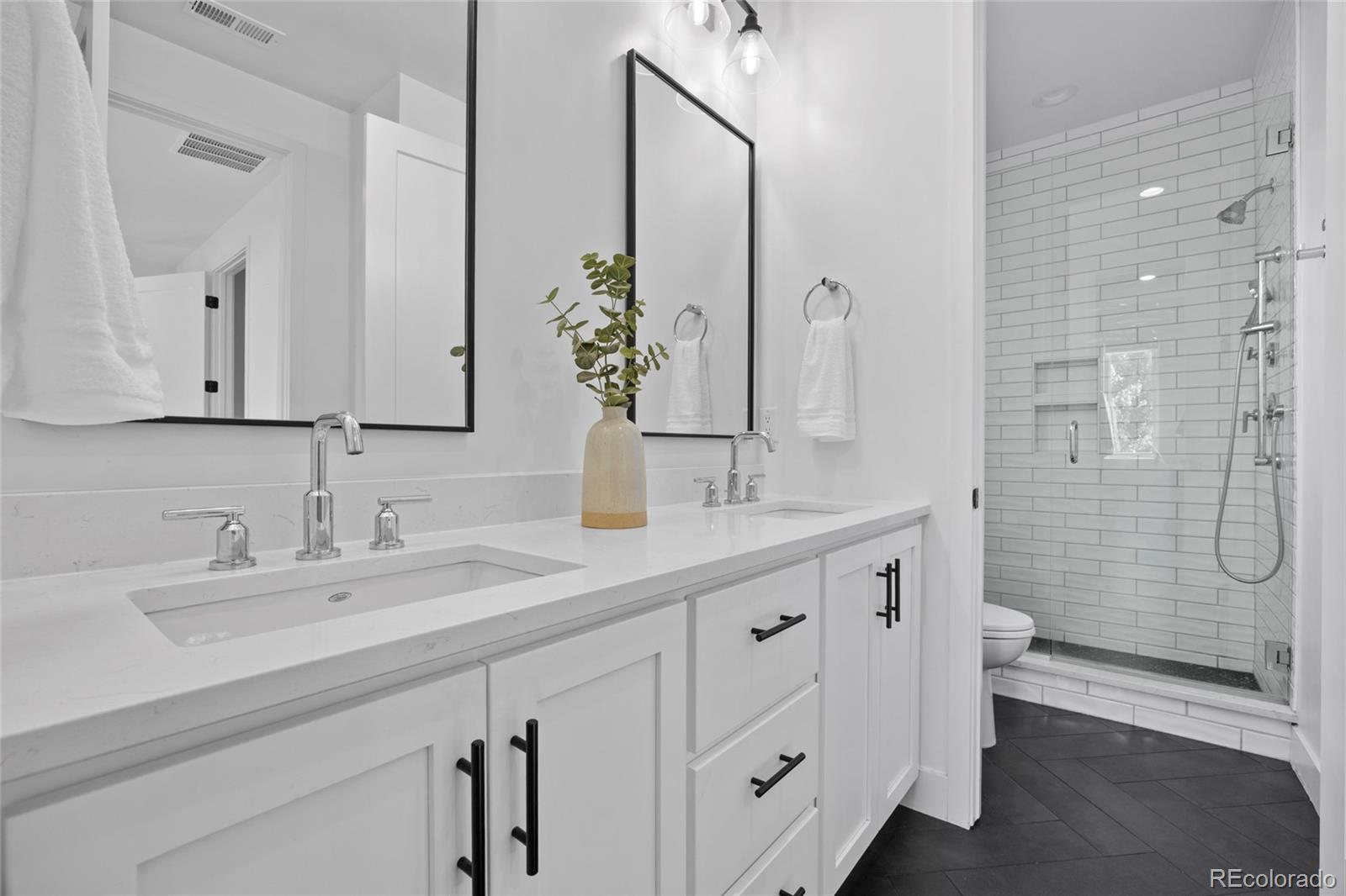 3922 Osage Street Denver, CO 80211 - Photo 22 of 44 a bathroom with a double vanity sink mirror and toilet