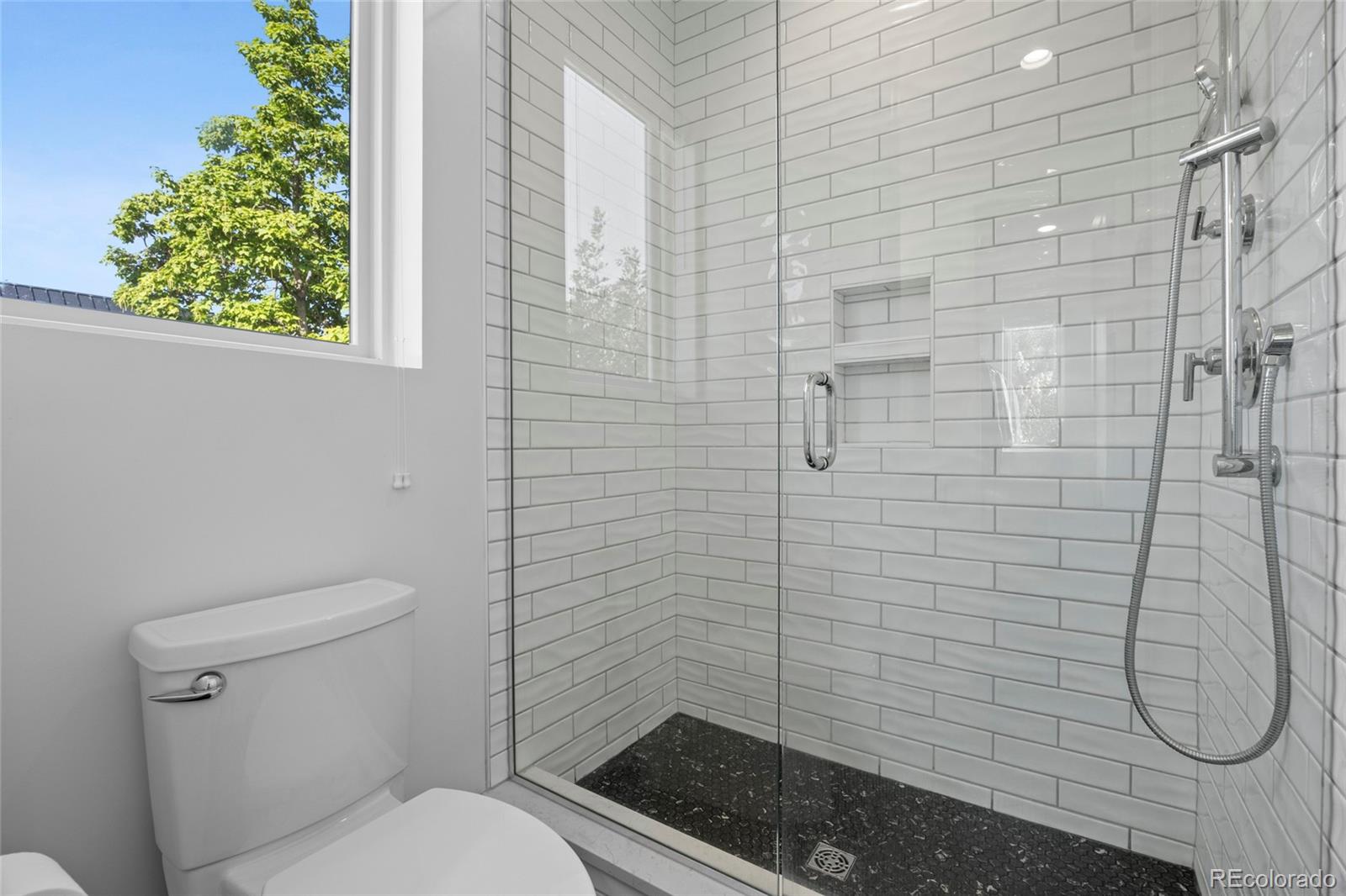 3922 Osage Street Denver, CO 80211 - Photo 23 of 44 a bathroom with a toilet and a shower