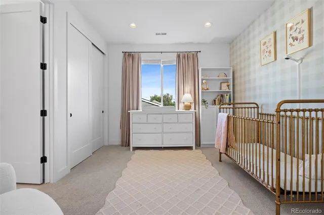 a bedroom with a bed and a mirror