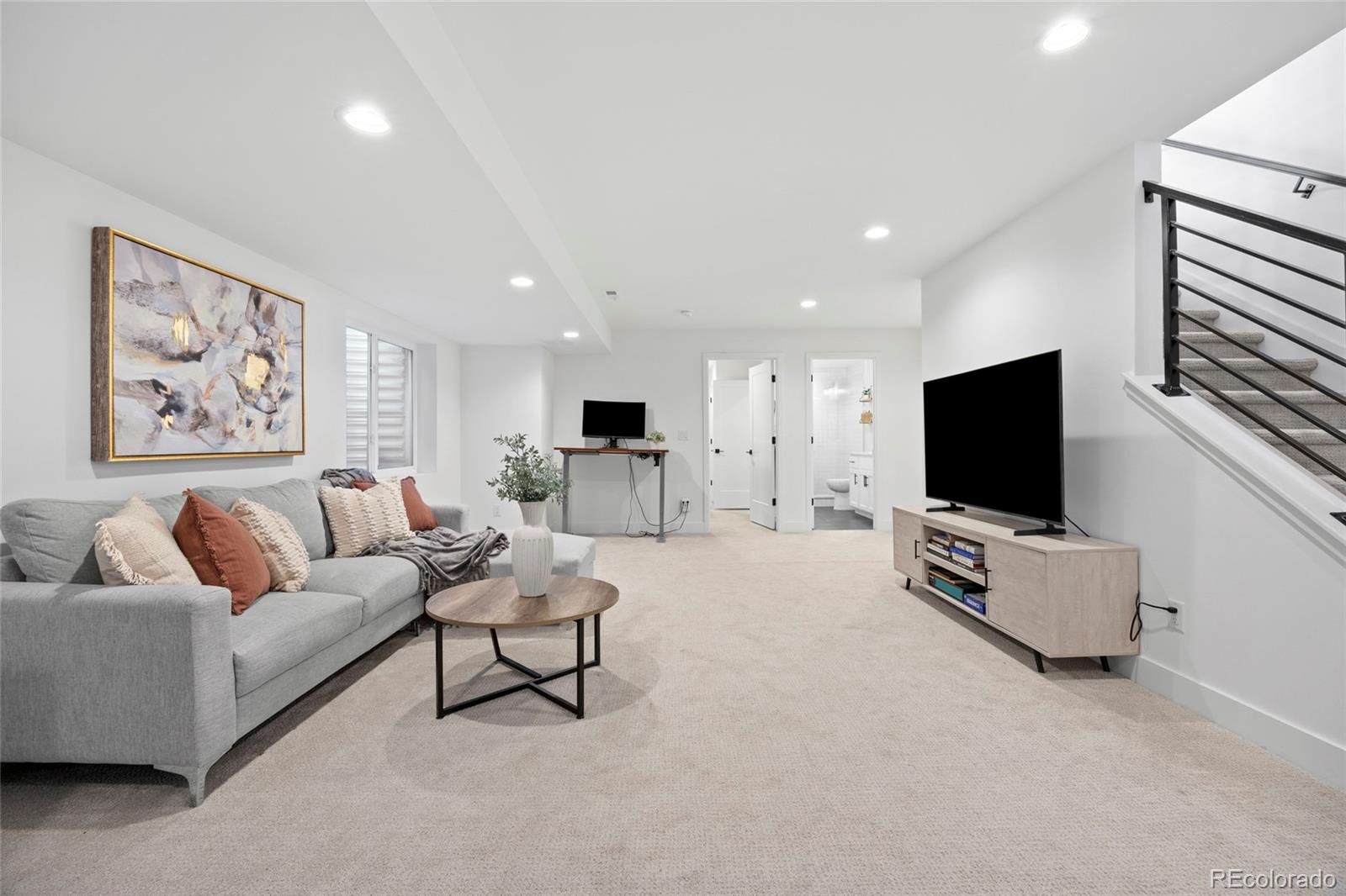 3922 Osage Street Denver, CO 80211 - Photo 31 of 44 a living room with furniture and a flat screen tv