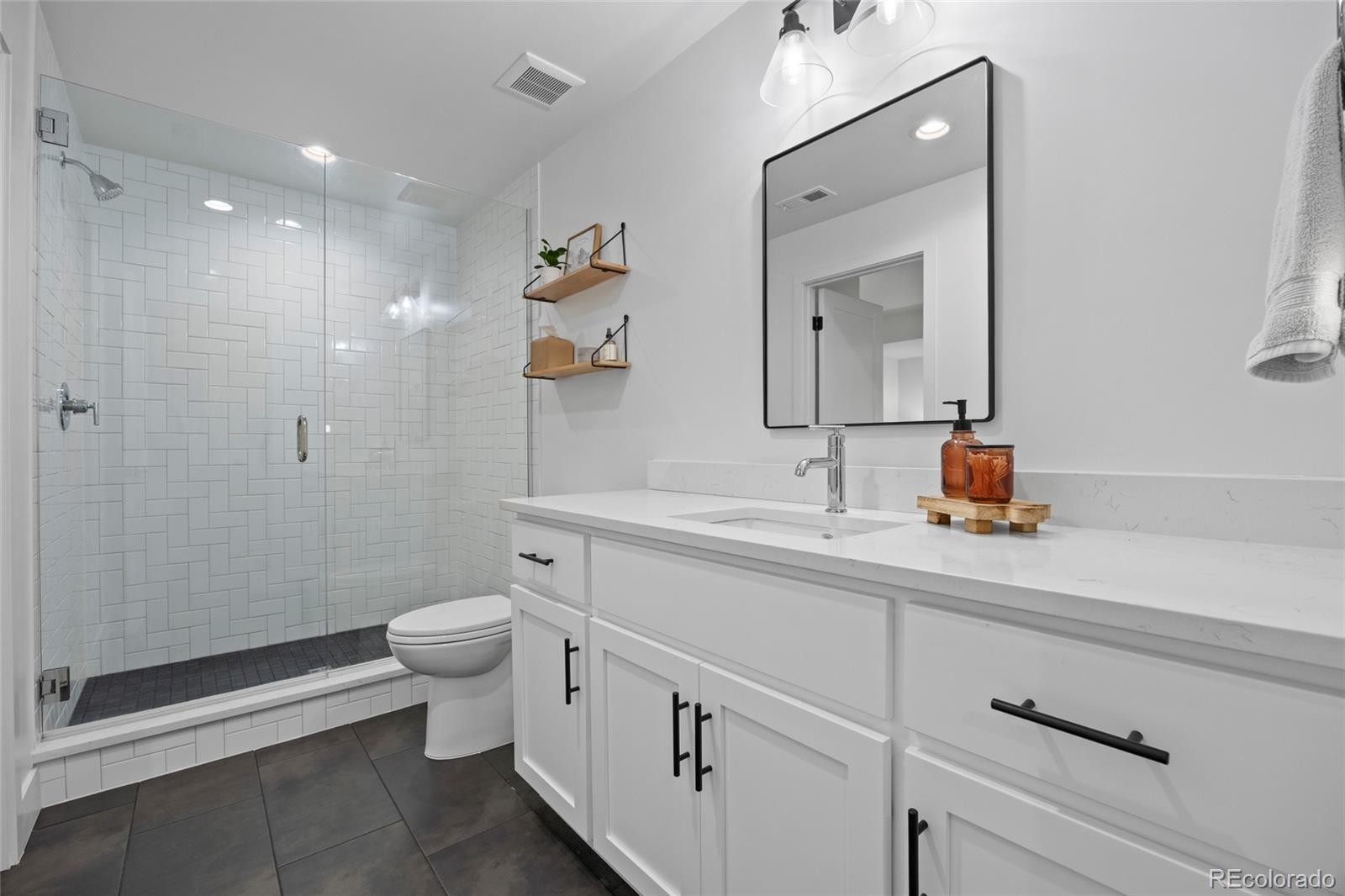 3922 Osage Street Denver, CO 80211 - Photo 33 of 44 a bathroom with a double vanity sink toilet and mirror