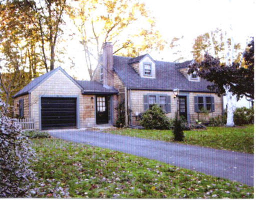 54 Blake Road Lexington, MA 02420 - Photo 1 of 1 a front view of a house with a garden and yard