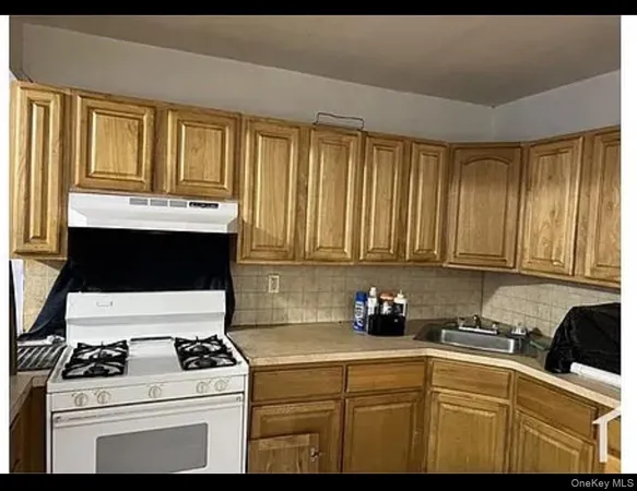 a kitchen with a stove and white cabinets