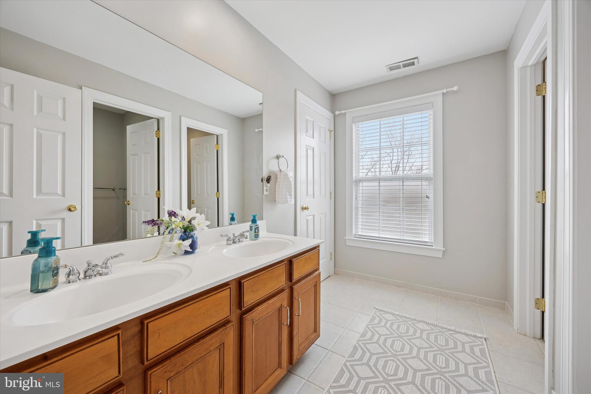 321 Lenni Road Lenni, PA 19052 - Photo 24 of 35 a bathroom with a sink double vanity granite tub shower and a mirror