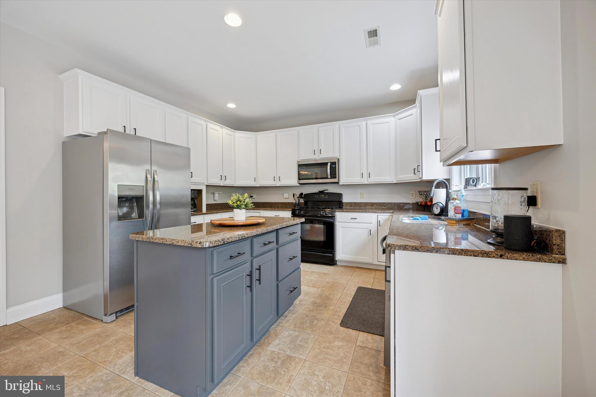 321 Lenni Road Lenni, PA 19052 - Photo 7 of 35 a kitchen with granite countertop a sink a counter top space stainless steel appliances and cabinets