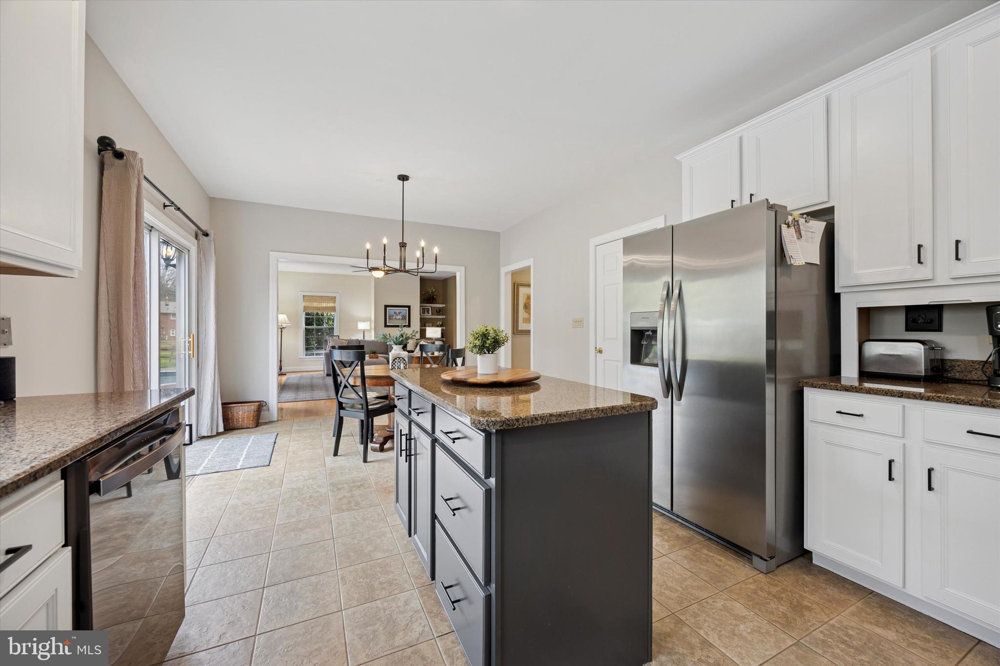 321 Lenni Road Lenni, PA 19052 - Photo 8 of 35 a kitchen with stainless steel appliances granite countertop a refrigerator a stove a sink a dining table and chairs with wooden floor