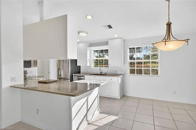 a kitchen with granite countertop a sink and a stove