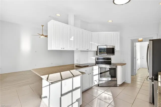a kitchen with stainless steel appliances a stove a sink and a refrigerator