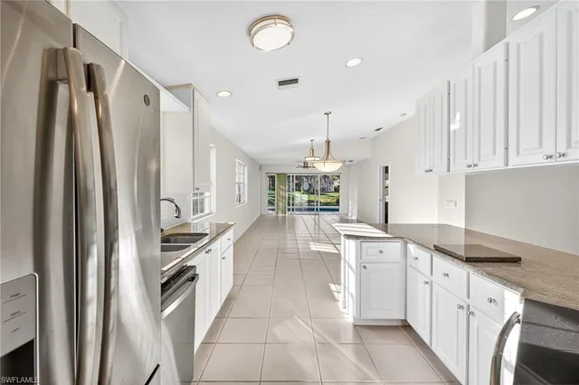 a large kitchen with cabinets and stainless steel appliances