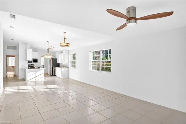 a view of a kitchen with furniture and a ceiling fan