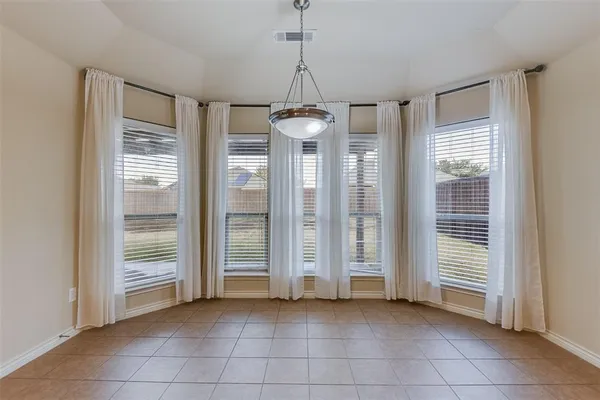 a view of a room with cabinet and windows