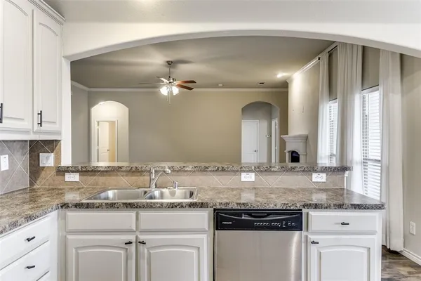 a bathroom with a granite countertop sink and a large mirror