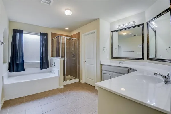 a bathroom with a double vanity sink and a mirror