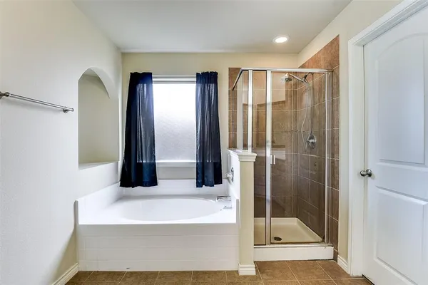 a bathroom with a bathtub and a shower