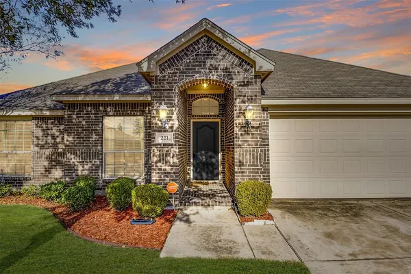 a view of a brick house with potted plants