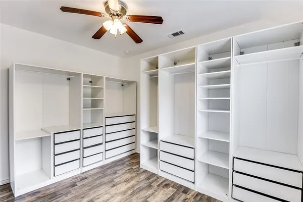 a view of walk in closet with empty racks
