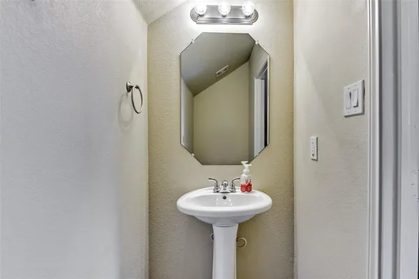 a bathroom with a sink and mirror