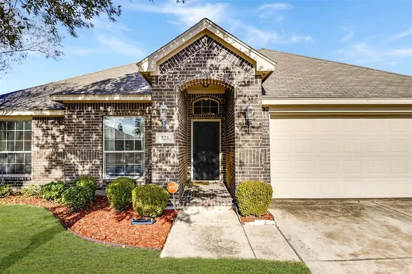 a view of a brick house with potted plants