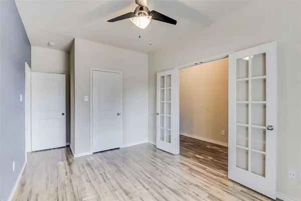 a view of empty room with wooden floor