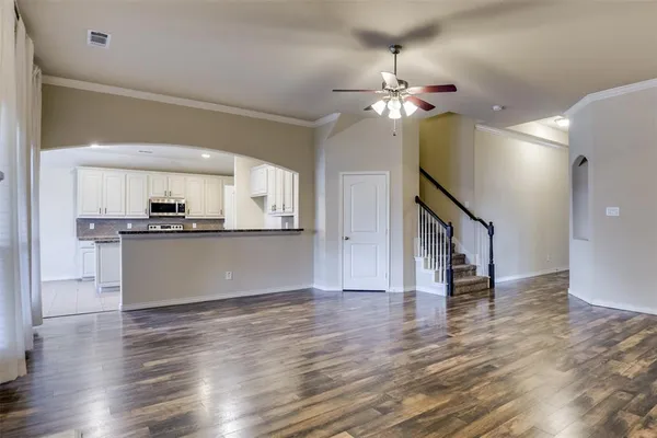 a view of a kitchen with wooden floor and a kitchen