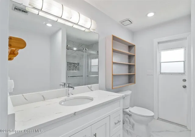 a bedroom with a large bed and a fireplace