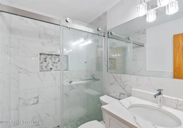 a view of kitchen with stainless steel appliances granite countertop a stove a sink and a refrigerator with white cabinets