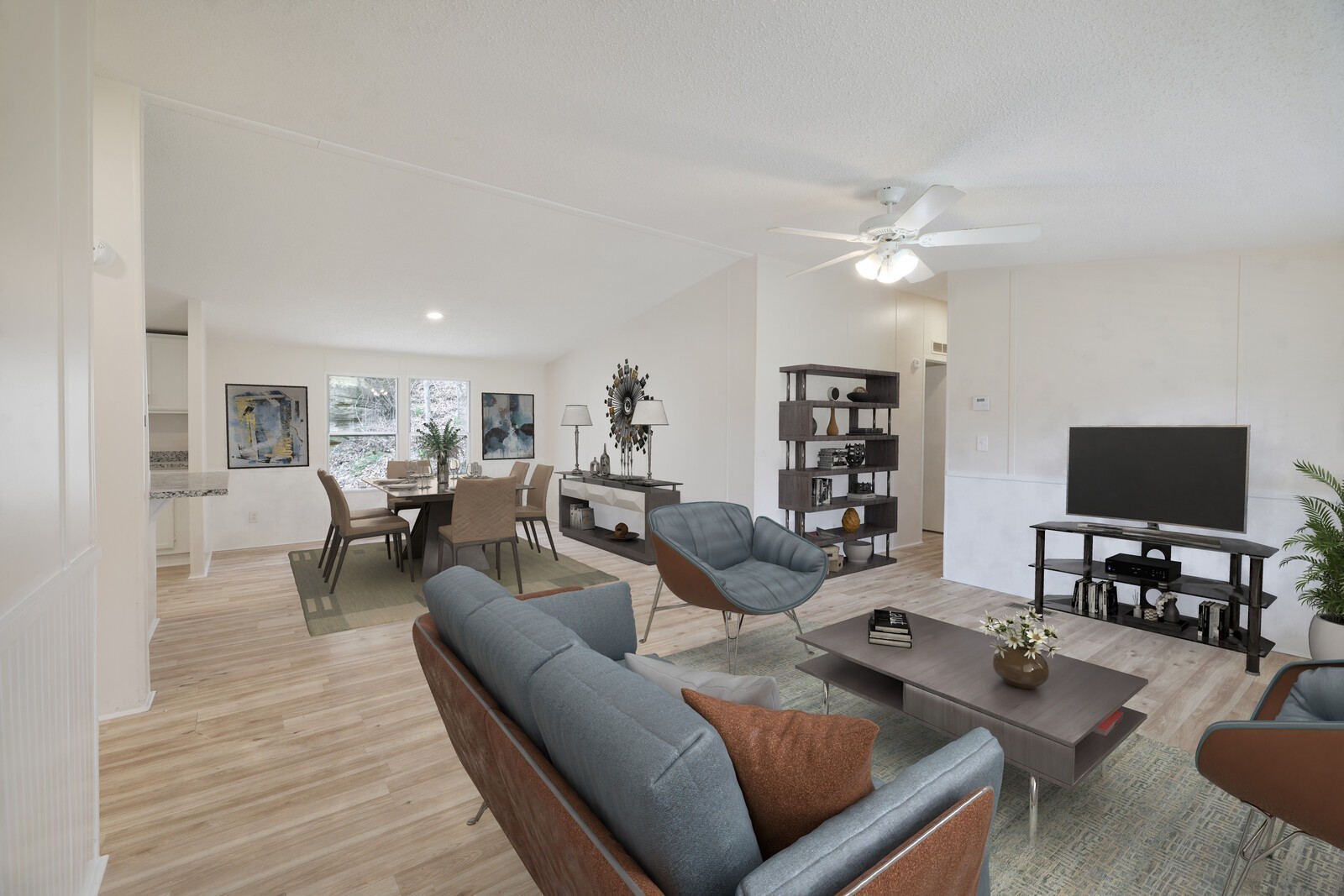 a living room with furniture and a flat screen tv with wooden floor