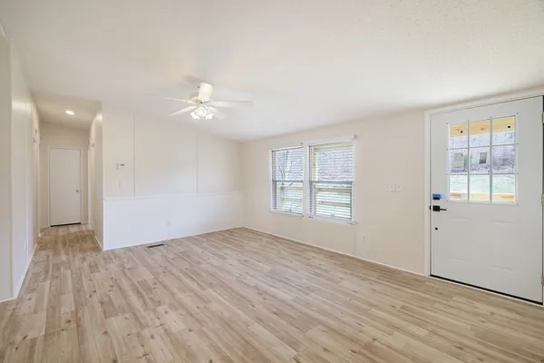 a kitchen with granite countertop white cabinets and white appliances