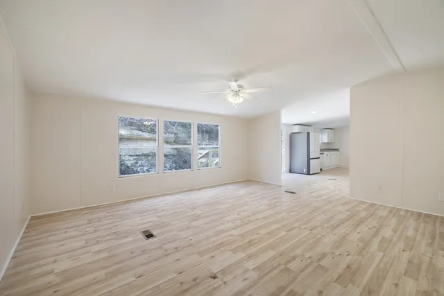 wooden floor in an empty room with a window