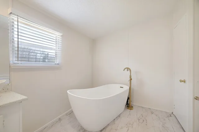 a white bath tub sitting in a bathroom