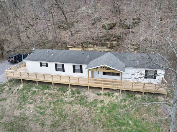 an aerial view of a house with a yard