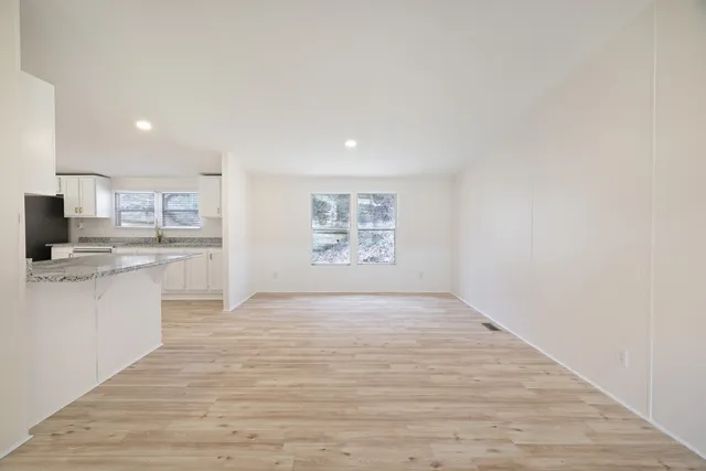a view of kitchen with wooden floor and electronic appliances