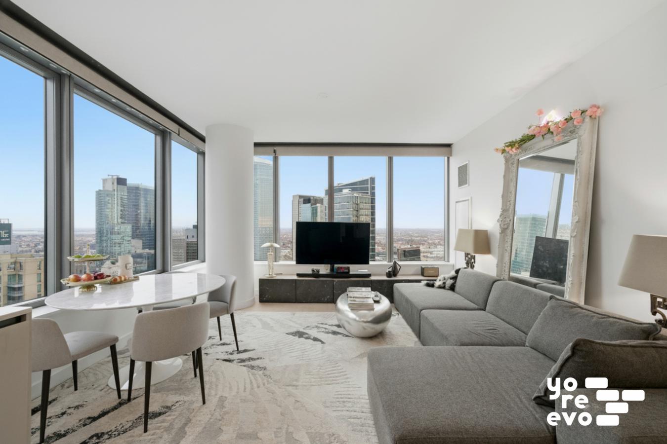 3 Court Square, Unit 4308 Queens, NY 11101 - Photo 1 of 13 a living room with furniture and a large window
