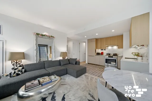 a living room with furniture and a large window