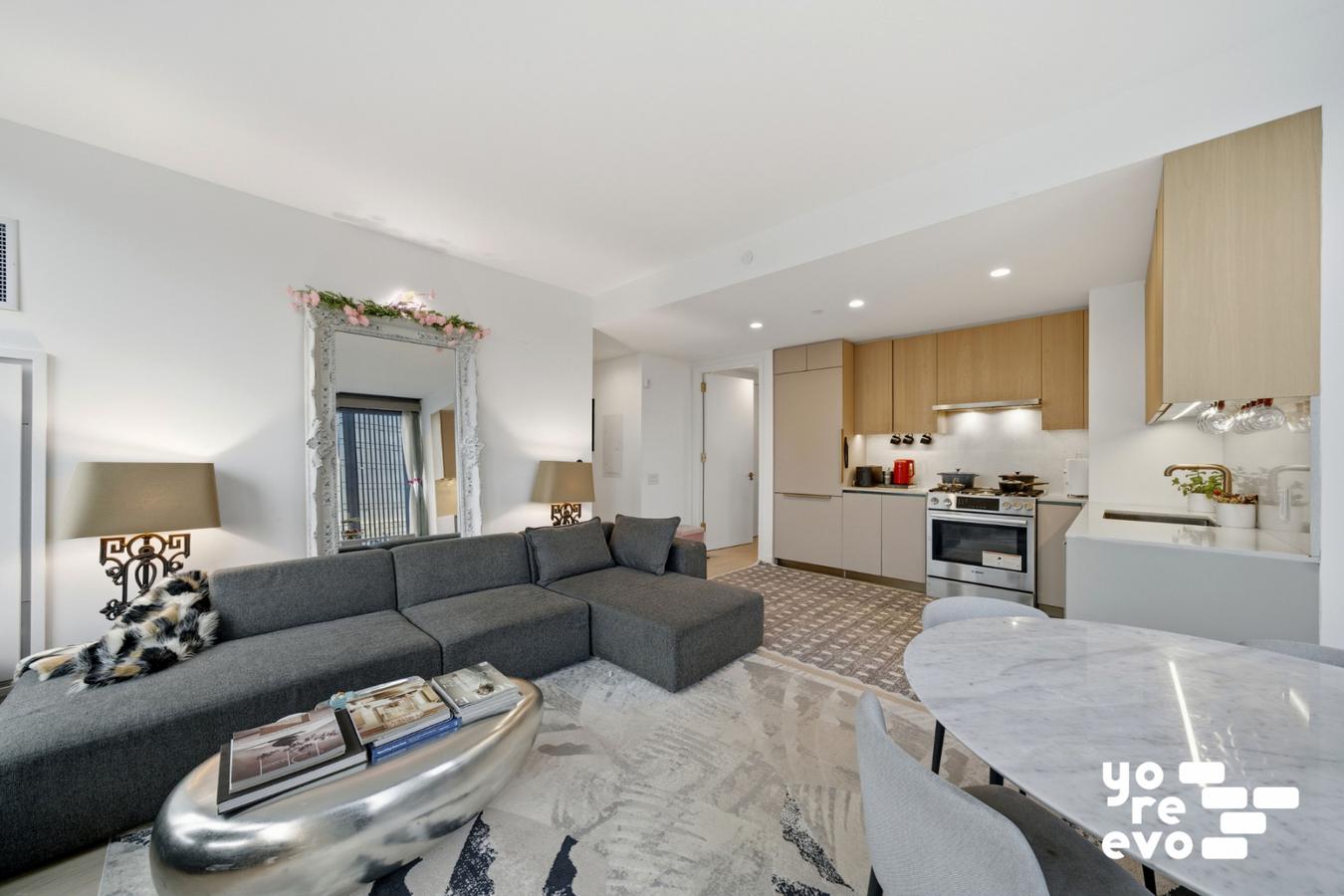 3 Court Square, Unit 4308 Queens, NY 11101 - Photo 2 of 13 a living room with furniture and a dining table with kitchen view