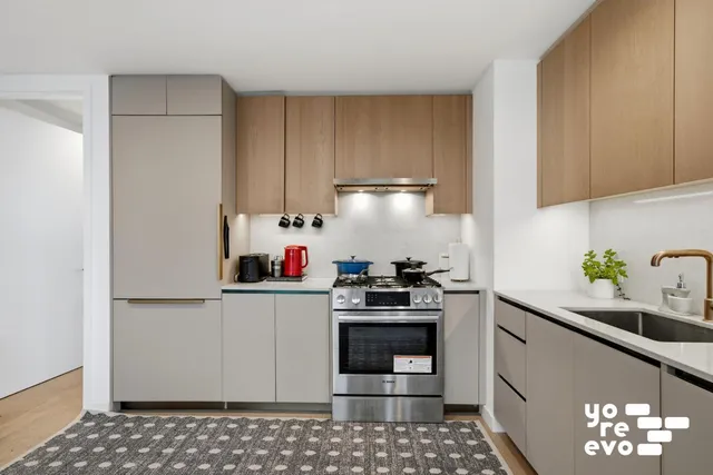 a living room with furniture and a dining table with kitchen view