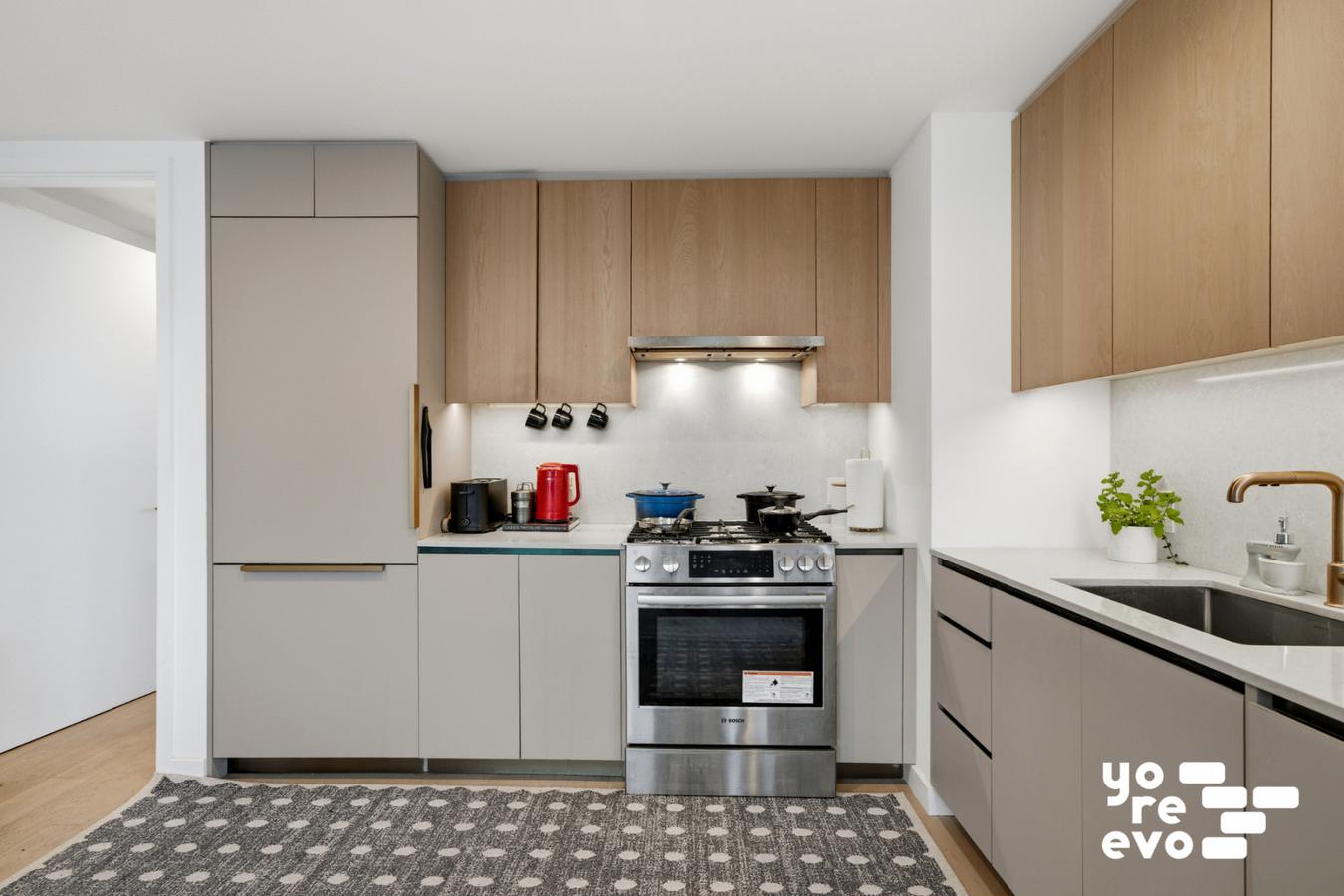 3 Court Square, Unit 4308 Queens, NY 11101 - Photo 3 of 13 a kitchen with a stove and a refrigerator