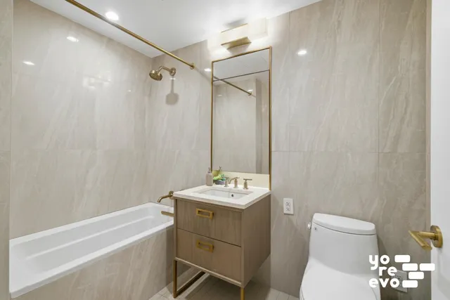 a bathroom with a double vanity sink toilet and shower