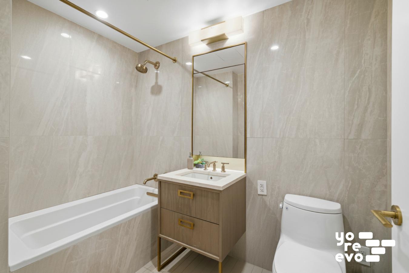 3 Court Square, Unit 4308 Queens, NY 11101 - Photo 6 of 13 a bathroom with a sink toilet and shower