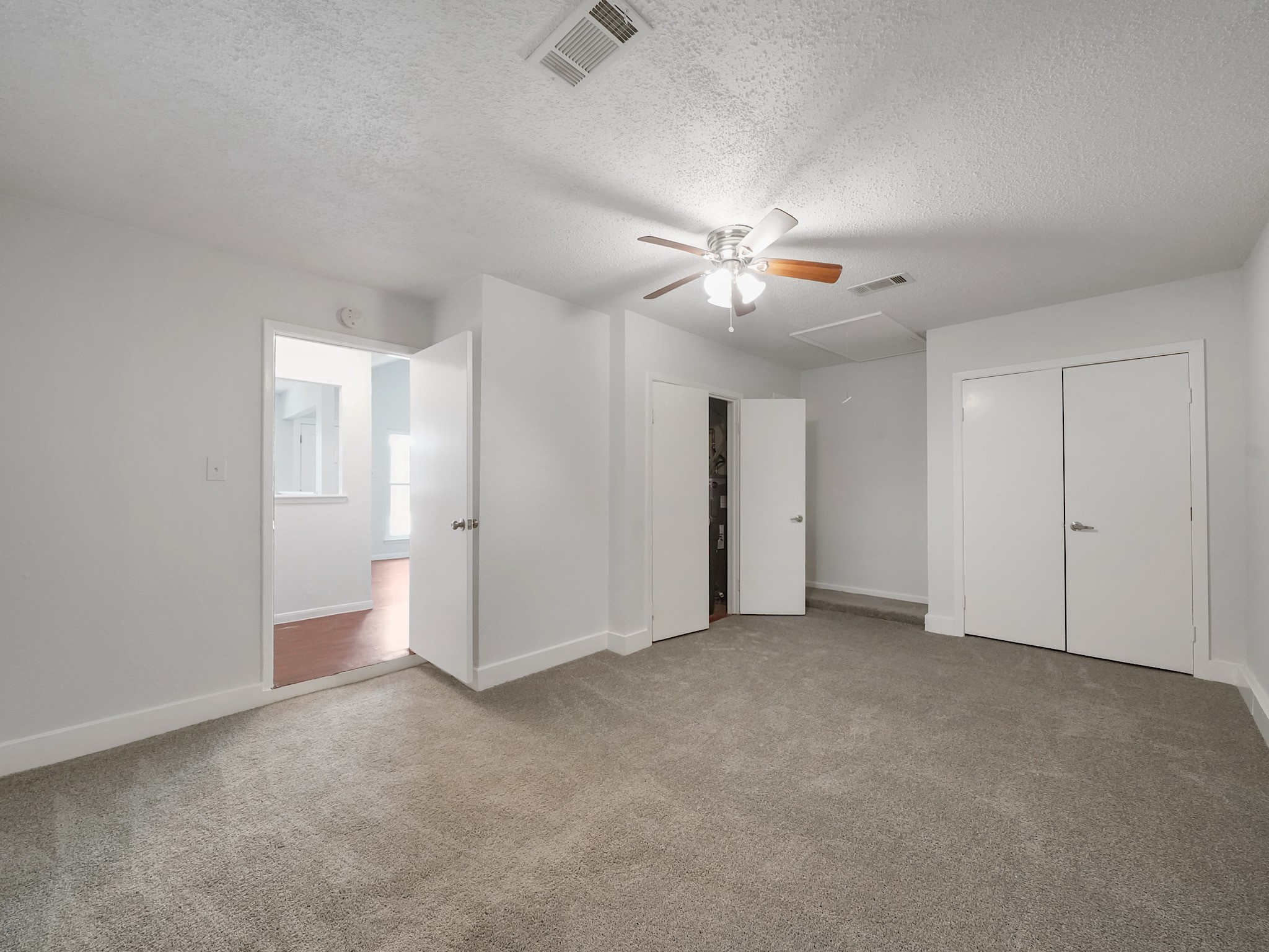 23338 Prairie Bird Drive Spring, TX 77373 - Photo 13 of 18 a view of an empty room with a ceiling fan